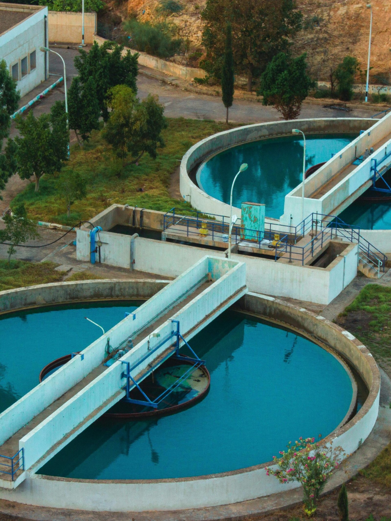 Drone shot of an advanced water purification plant surrounded by trees.